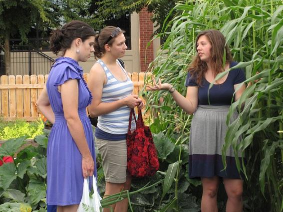 Senior Katie Kann (right) discusses organic gardening with a fellow senior in the garden Sept. 3.