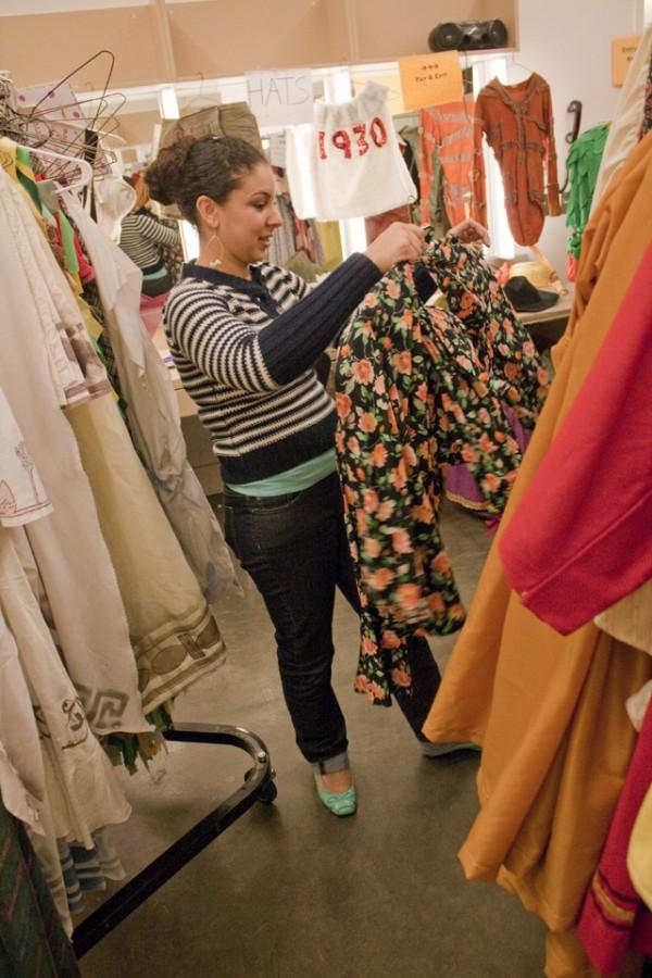 Alethia Moore-DelMonaco, instructional associate, costume designer and costume shop manager, organizes one of the costume pieces during the theater programs first Halloween Costume Sale on Oct. 21.  Katie Paysinger/Senior photographer 