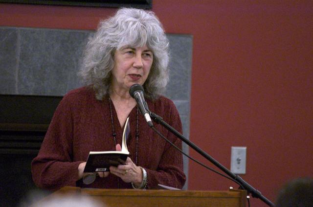 Oregon Poet Laureate Paulann Petersen reads Whitman-inspired poetry from her new collection, “The Voluptuary,” to a crowded audience Nov. 30 in Nicholson Library. Joel Ray/For the Review