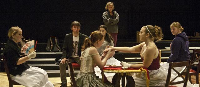 Freshman Kay Bartlett (far left), feshman Cole Curtwright (sitting in back), senior Rachel Westrick (left side of table), junior Kanon Havens (right side of table), freshman Gabrielle Leif (sitting in back), and junior McKenna Peterson (far right) practice for “West Moon Street” as director Elizabeth Rothan (standing) oversees the rehearsal.  Katie Pitchford/Photo editor