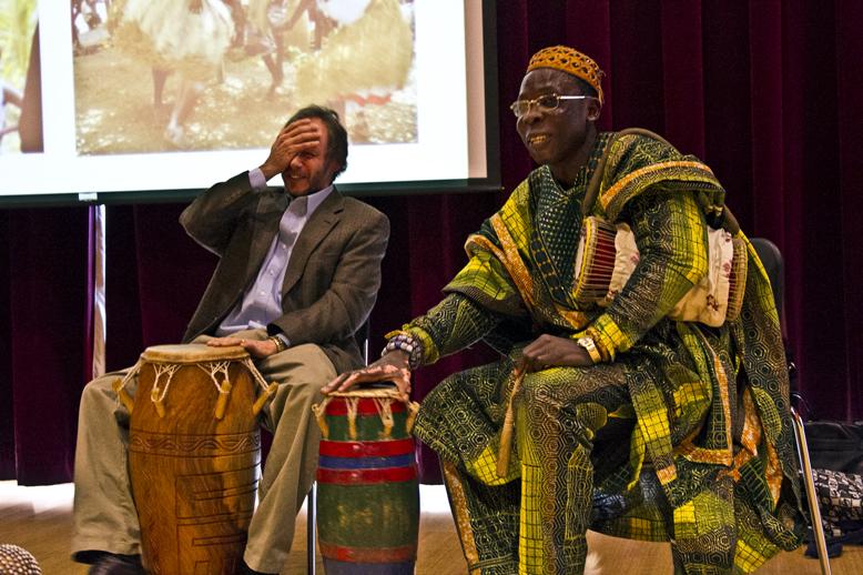 Barry Bilderback (left) laughs after missing a beat while perfoming with guest Hunor Gatukpe Dogah on March 12. Megan Myer/Online editor