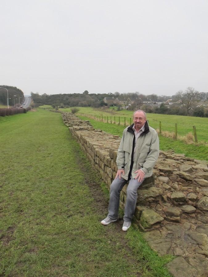 Professor of Mass Communication William Lingle sits on Hadrian’s Wall in England during his British Mass Media course in January Term 2010.