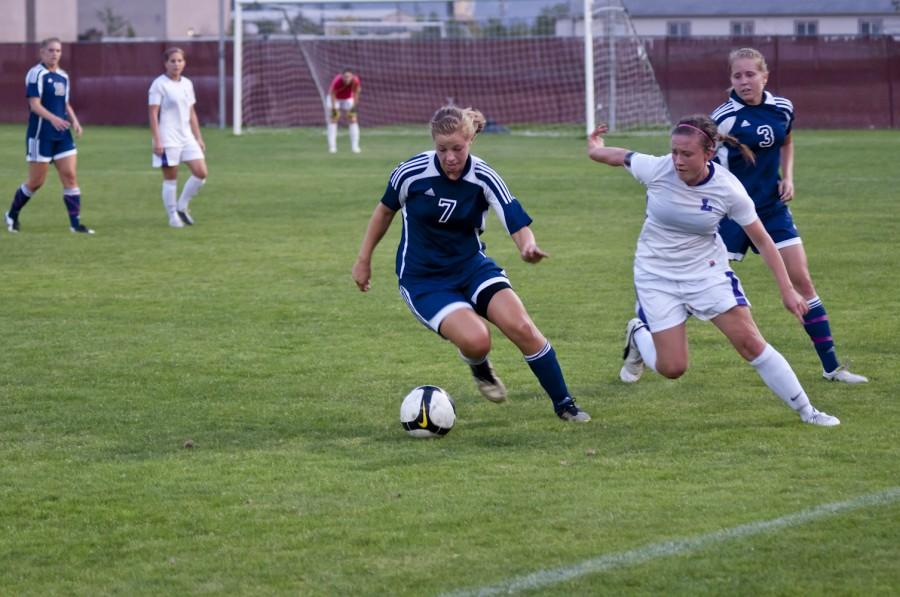 Junior mid fielder Anna Sours moves to steal the ball from Corban’s forward Sept. 10.  Joel Ray/Photo editor