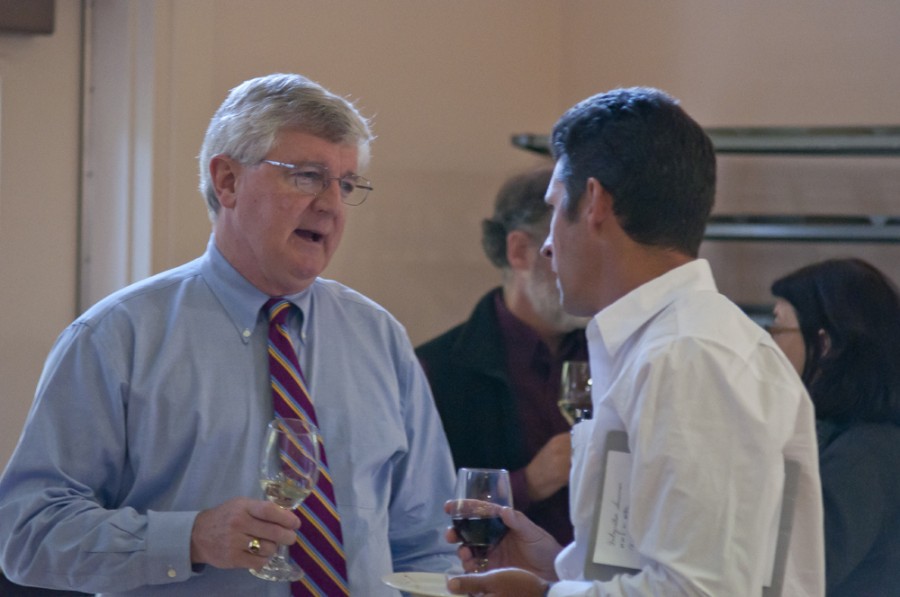 George D. Kuh, a guest speaker from Indiana University shares a glass of wine while talking to others at the reception following his lecture. He presented a speech on the importance of preparation Sept. 19 in Ice Auditorium. Joel Ray/Photo editor