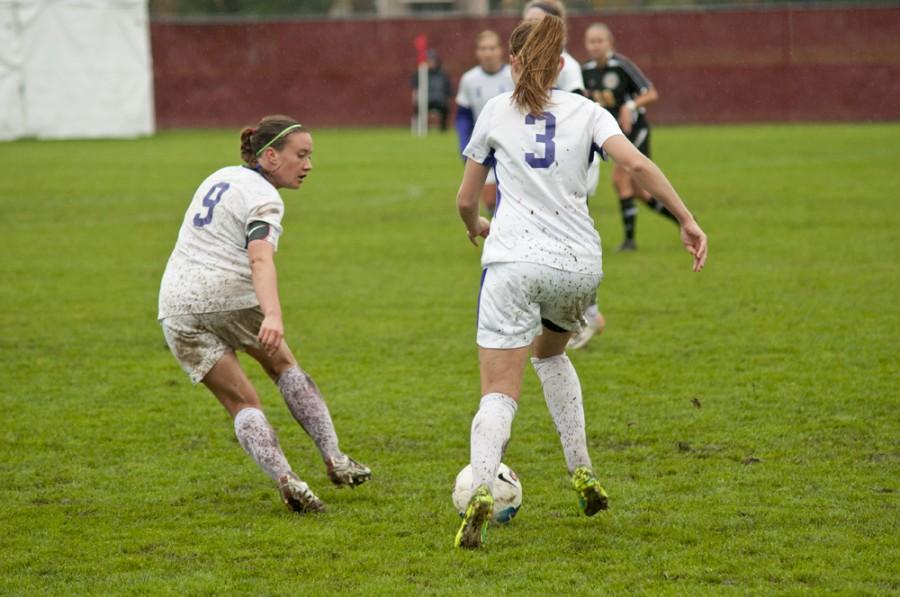 Junior Anna Sours and sophomore Stephanie Socotch pass the ball between each other, dribbling down the field toward Whitman’s goal Nov. 5 at home. 	Joel Ray/Photo editor