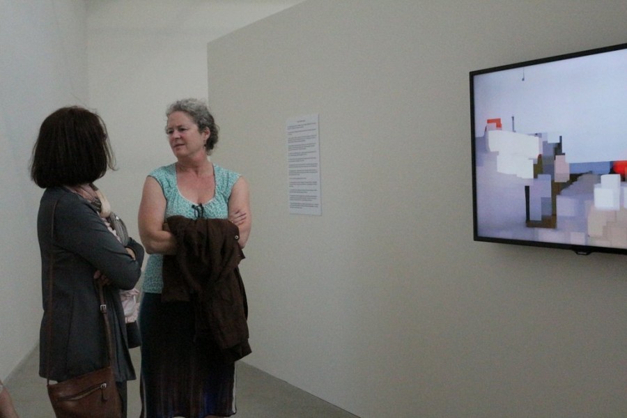 Two women discuss Peter Campuss piece at his Artist Talk on Aug. 27 in The Linfield Gallery. 