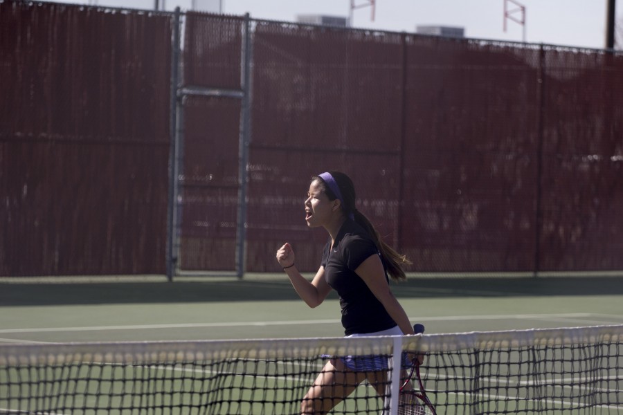 Senior Kaila Nip celebrates after winning the March 7 doubles match against George Fox with a score of 8-2.