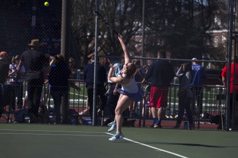 Freshman Marisa Doveri practice her serve before starting a singles match against George Fox University on March 7.