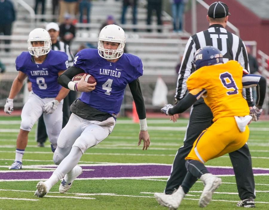 Tom+Knecht+16+carries+the+ball+during+the+third+quarter+of+Linfields+matchup+against+University+Mary-Hardin+Baylor.+The+Wildcats+won+38-35.