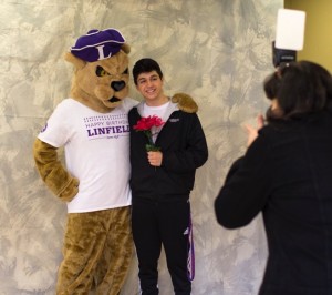 Israel Fregoso '19 poses with Mac the Wildcat at Linfield's birthday celebration.