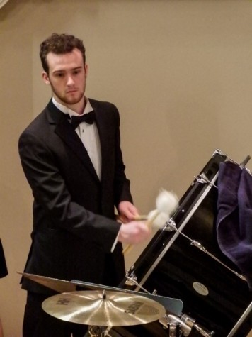 Jeff Laws, '16, plays the drum in “Cloudburst” during the Linfield choir's  home concert on Wednesday, Feb. 24.