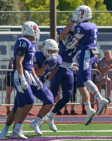 Linfield celebrates after the first touchdown of the game against the Chapman University Panthers.
