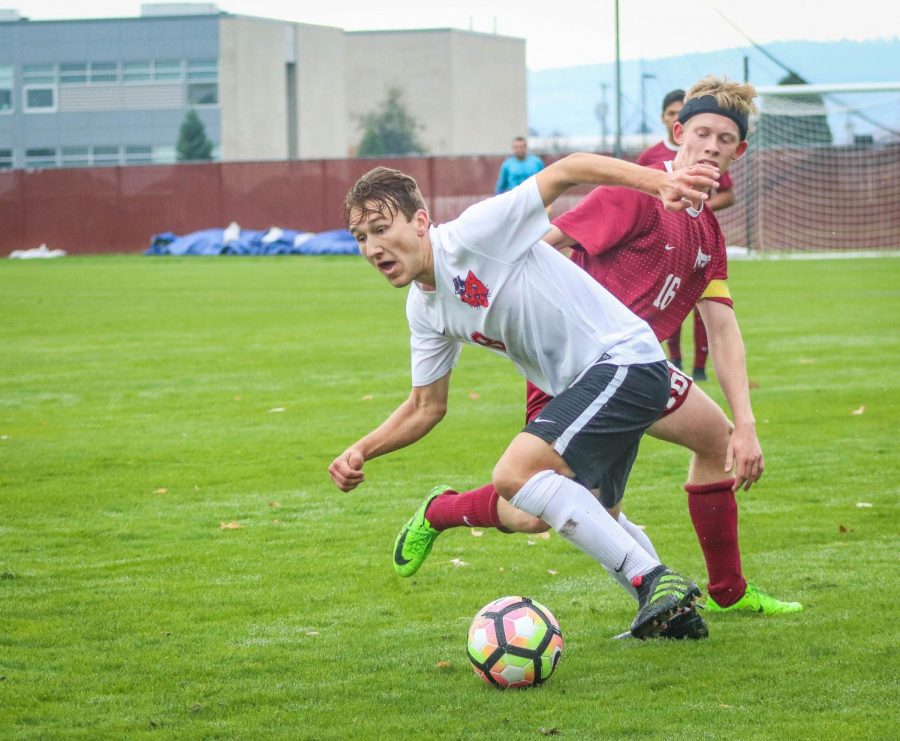 Austin Bebee 18, jukes around an opposing player for possession of the ball in the 2nd half of the match versus Willamette on November 4th. 