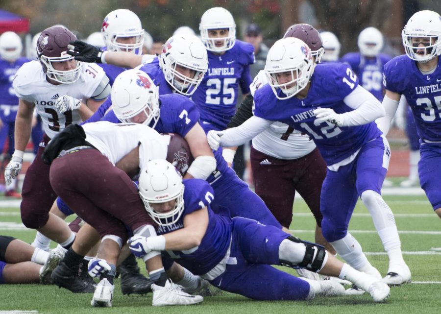 Linfield players 7 Jason Ferlow, 12 Nate Smaple, and 10 Blake Burnette make a huge tackle against Pudget Sound during the first quarter.  
