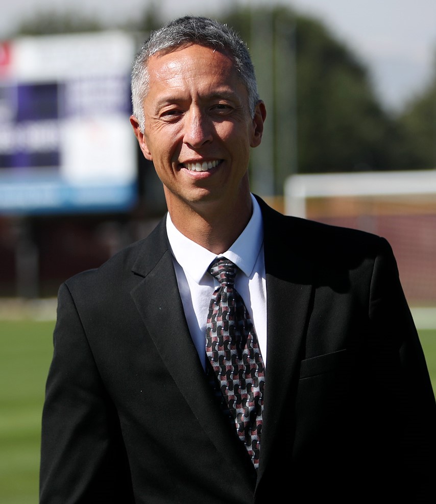 Steve Simmons stands on the grass field used by Linfield's soccer and lacrosse teams.
