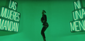 Female dancer in front of green background.