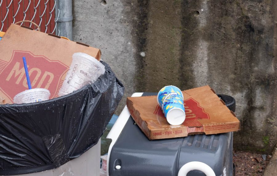 Trash piled up on wet ground