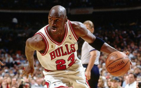 Michael Jordan in Bulls jersey with basketball in hand