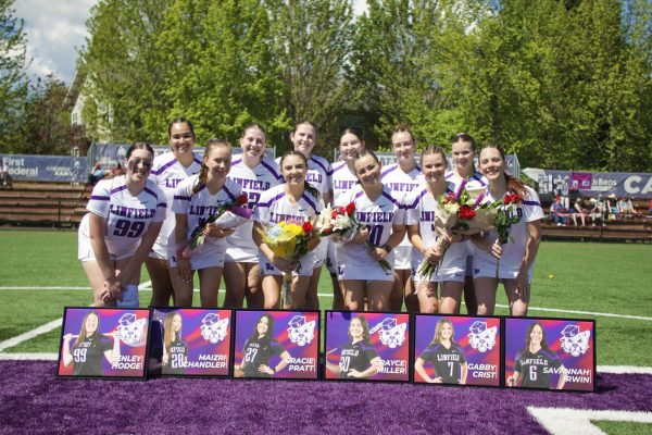 The women's lacrosse team poses at senior night