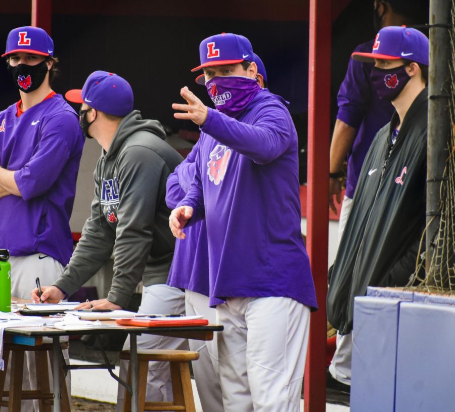 Coach+Dan+Spencer+communicates+with+players+on+the+field+during+Linfield+baseballs+home+opener+last+weekend.+