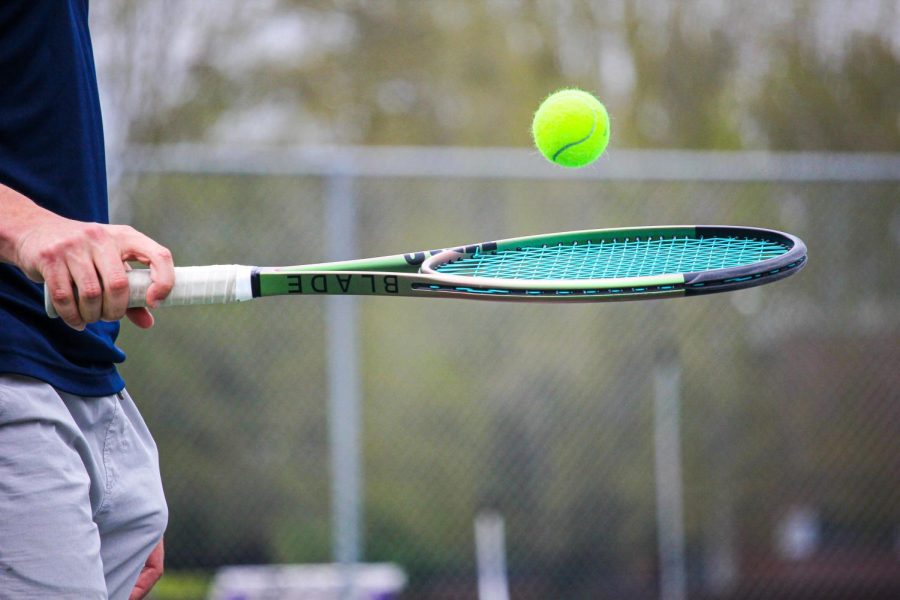 Young practicing with his racket. 