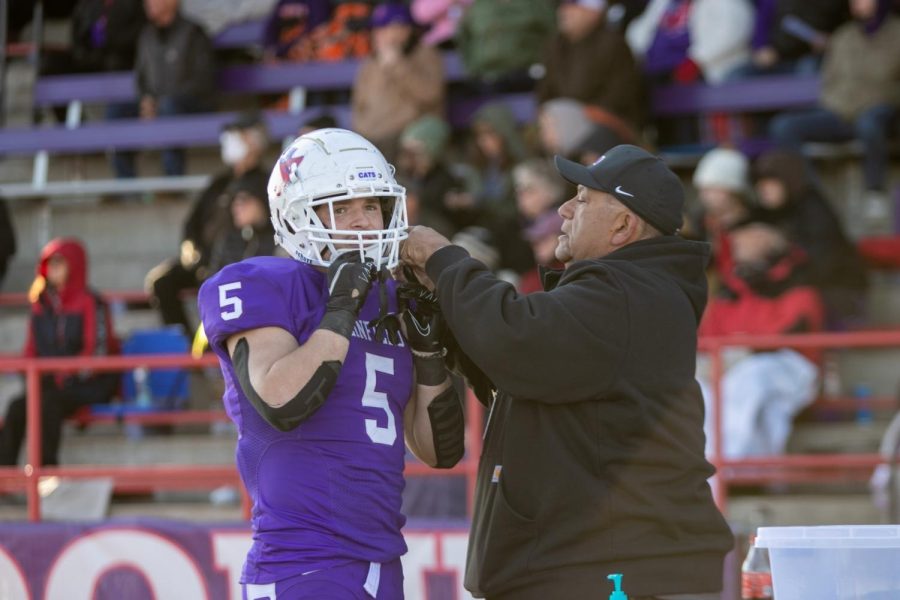 McNabb gets help from equipment coordinator Mack Farag.