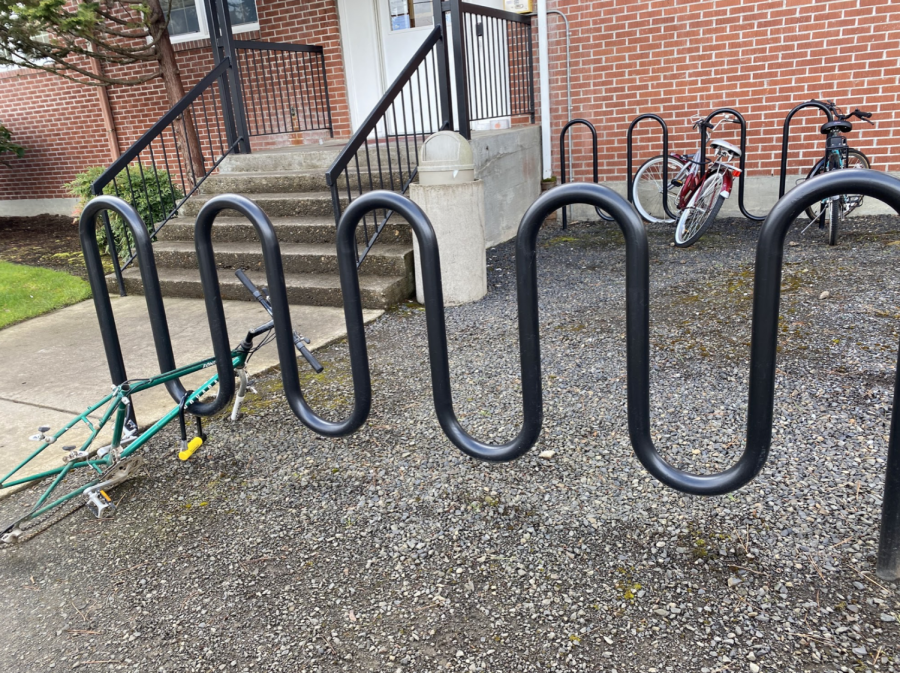 A students bike missing its seat, and both wheels. 