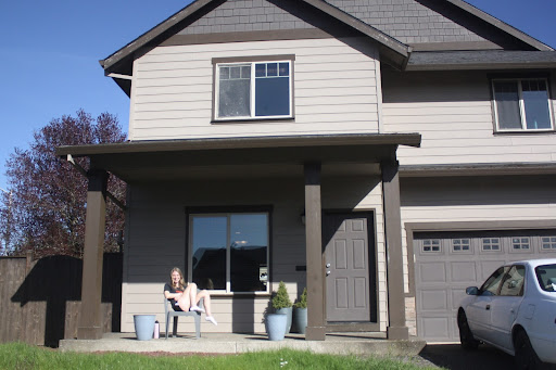 Senior Megan Sweeney enjoys the sun on the front porch of her off campus house. (Laney Green)