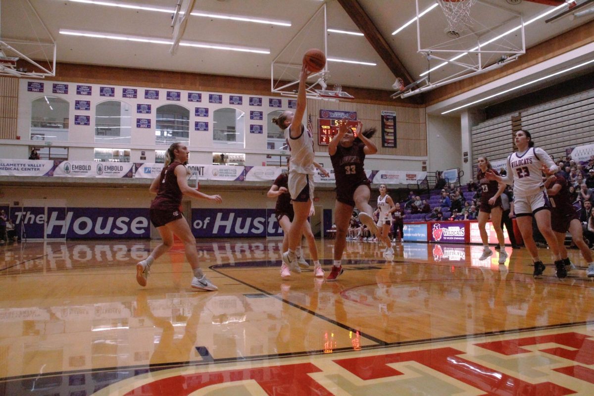 Junior Allie Mead shoots a layup over Puget Sound defenders on Feb. 14.